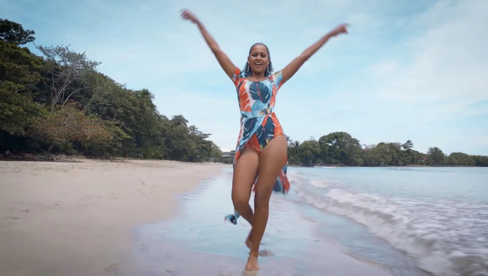 An artist celebrating on a Costa Rican beach